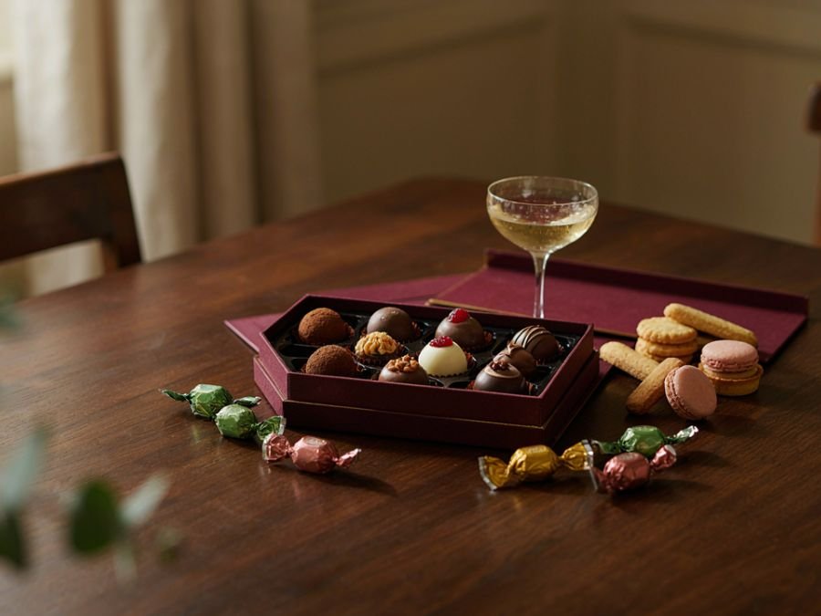 Assorted chocolates and truffles arranged on a wooden table